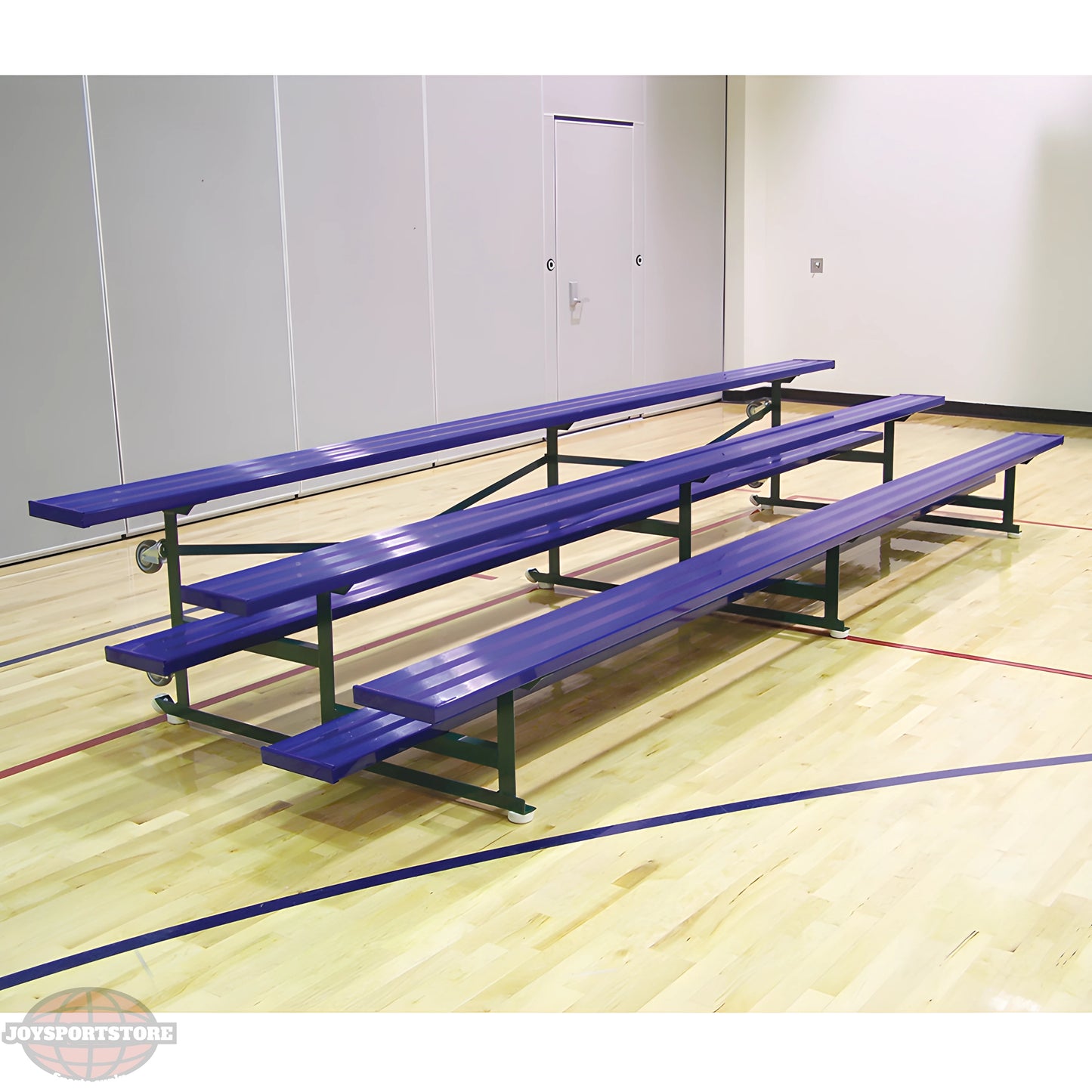 Blue metal bleachers on gymnasium wooden floor with gray walls.