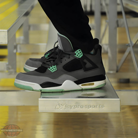 Person wearing sneakers sitting on indoor bleacher seats with aluminum frame.