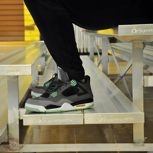 Person wearing sneakers sitting on indoor bleacher seats with aluminum frame