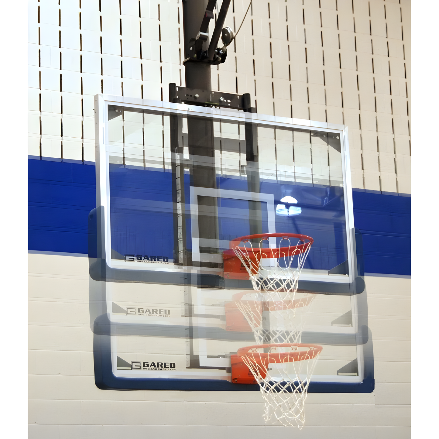 Gared basketball backboard with clear acrylic board and orange rim mounted on indoor gym wall