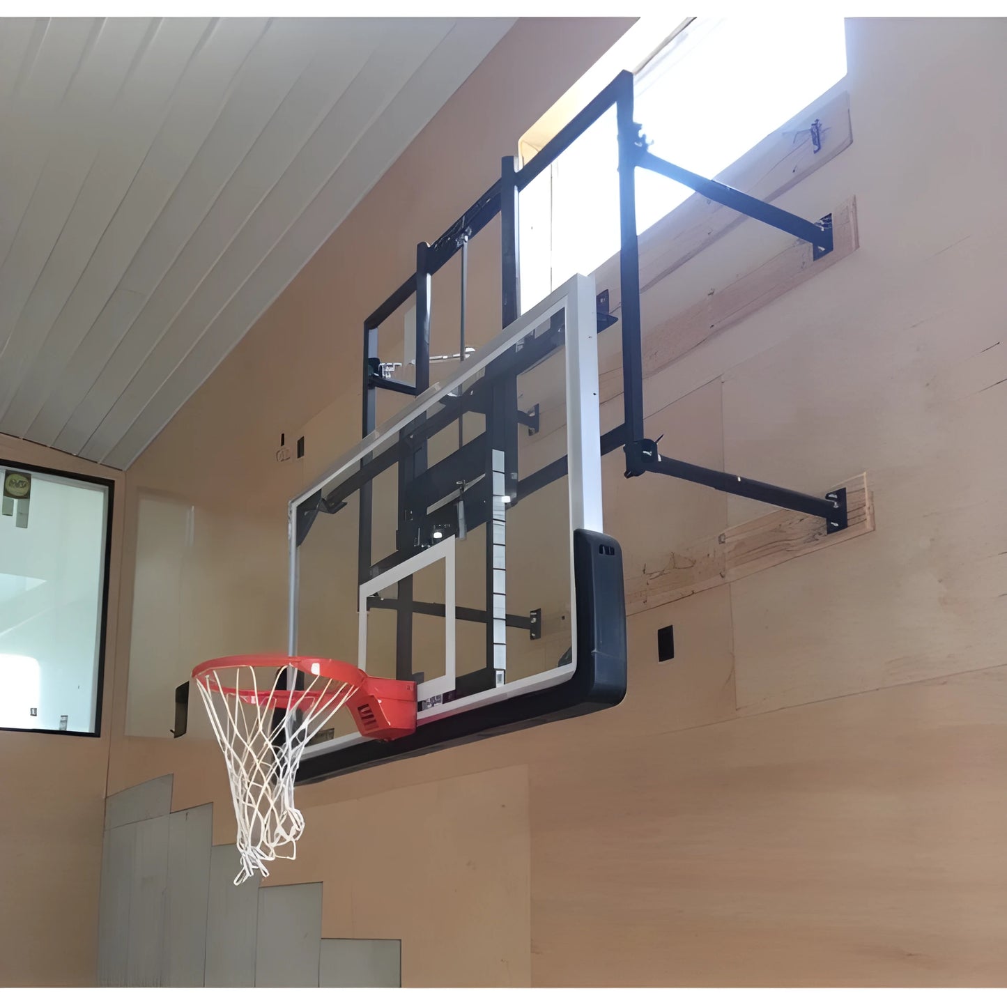 Gared basketball backboard mounted on indoor wall with black support brackets and orange rim
