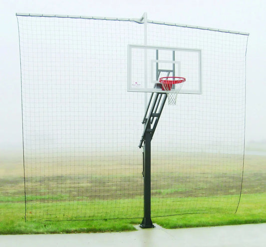 First Team FT22SU basketball hoop with adjustable black pole and clear backboard on a grassy field