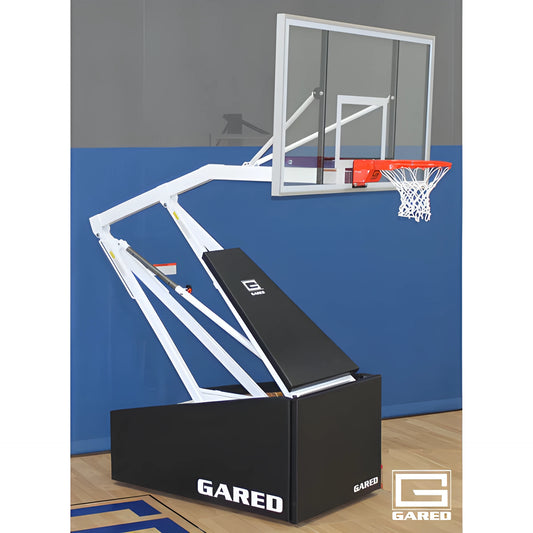 Gared basketball hoop with clear backboard and orange rim mounted on a black base in indoor gym