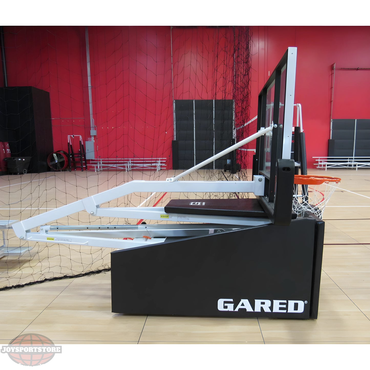 Gared basketball hoop system with adjustable support arms and black base on indoor court