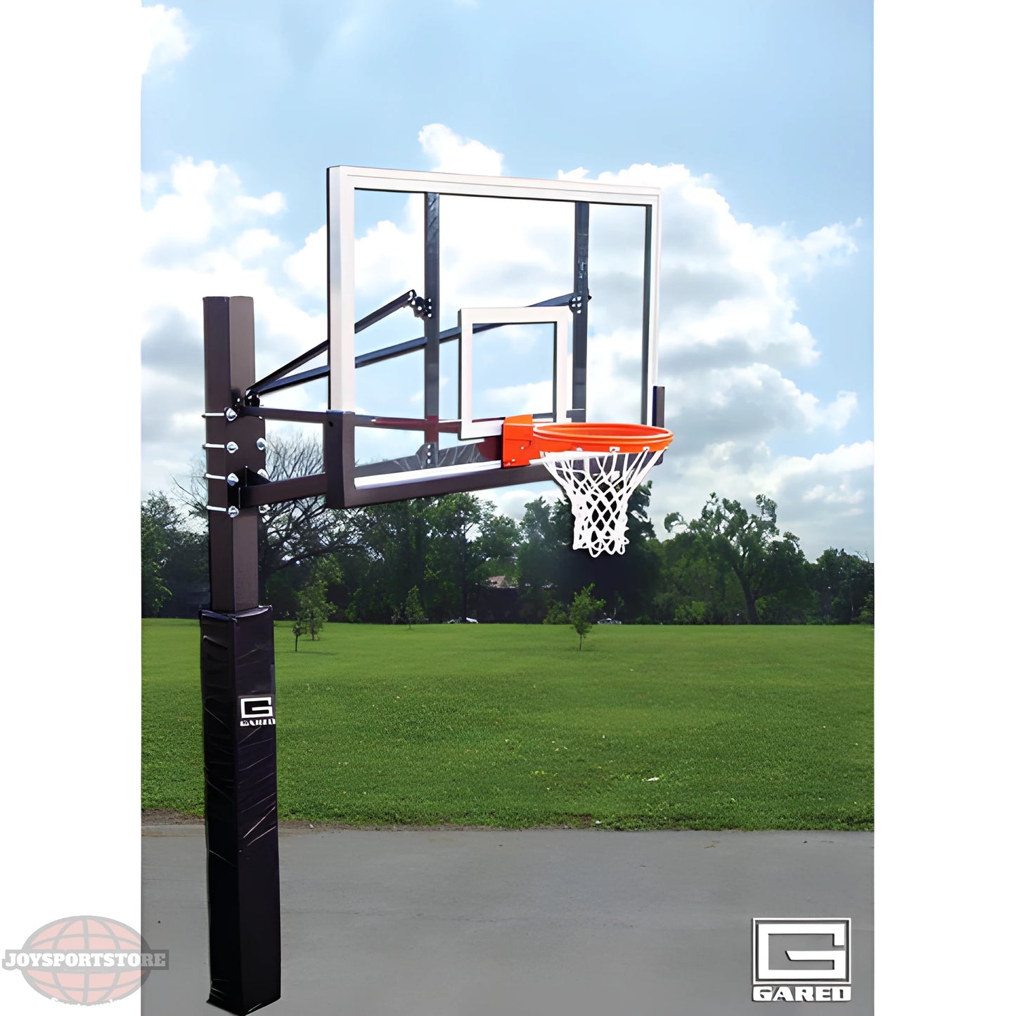 Gared outdoor ground basketball hoop with clear backboard and orange rim on a sunny day