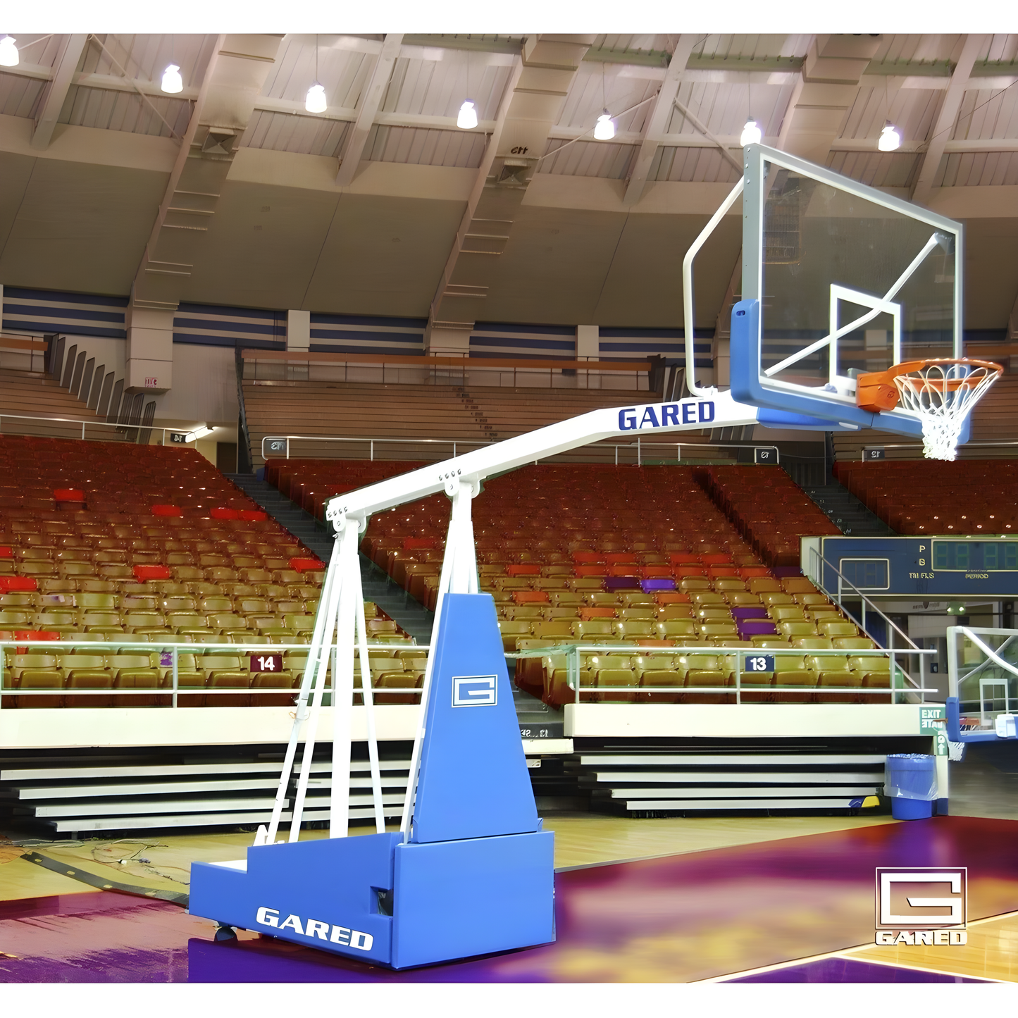 Gared portable basketball hoop with adjustable height and clear backboard on indoor court