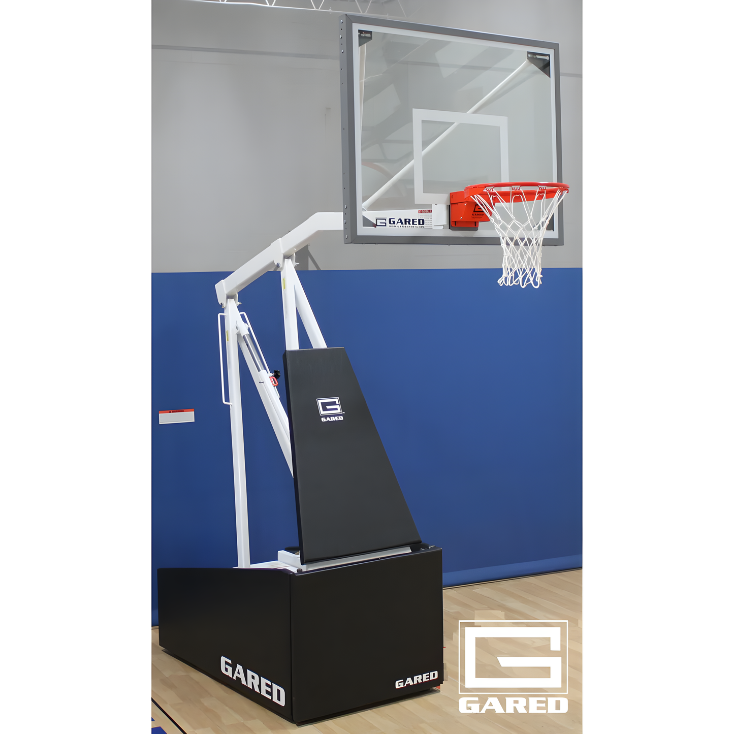 Gared portable basketball hoop with clear backboard and adjustable height on indoor court