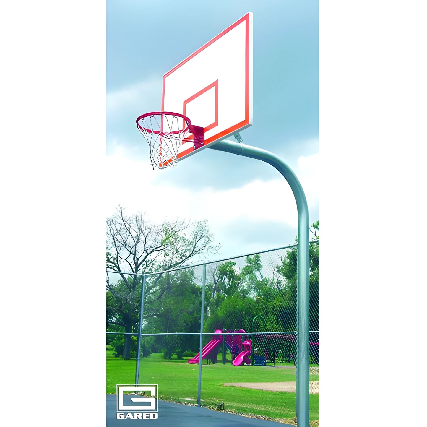 Outdoor basketball hoop with red rim and white backboard on a curved pole in a park setting