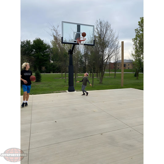 Ironclad Basketball Hoop with players shooting basketballs on an outdoor court