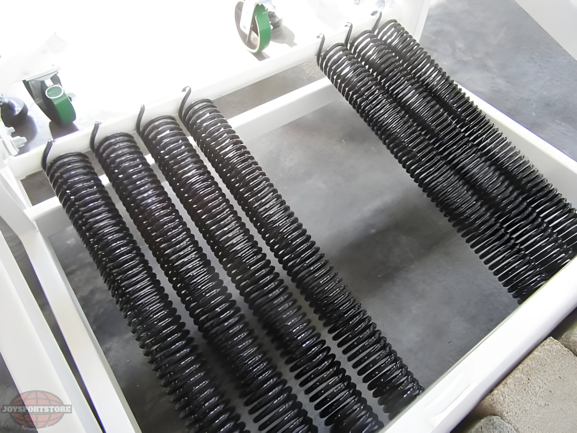 Close-up of black tension springs in a FIRST TEAM portable basketball hoop base