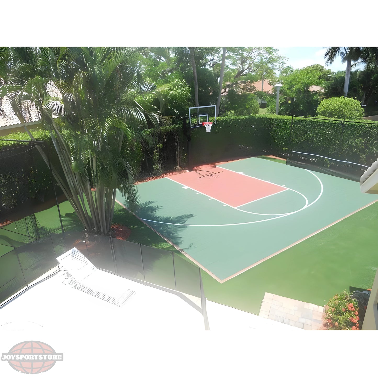 Jaypro outdoor basketball hoop installed on a residential green and red court surrounded by palm trees and hedges