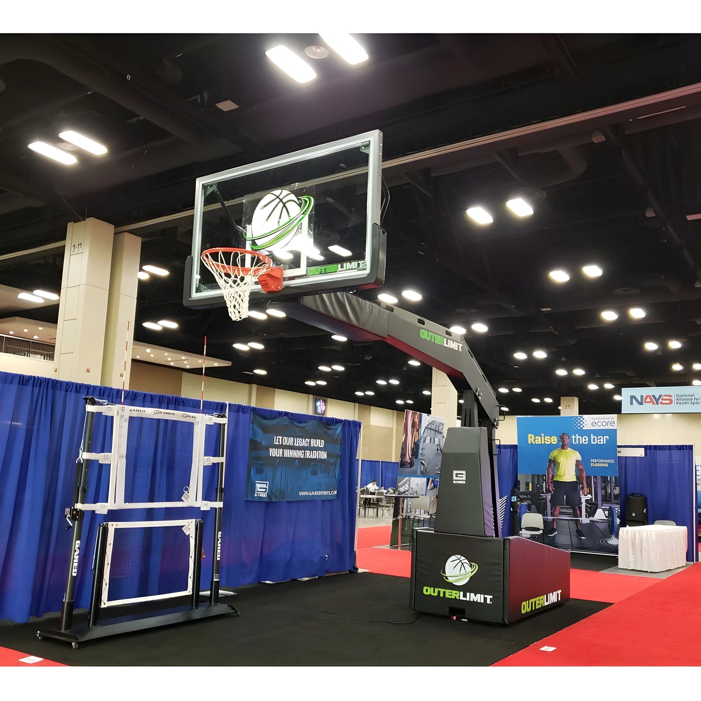Gared portable basketball hoop with adjustable backboard and base displayed indoors at an event