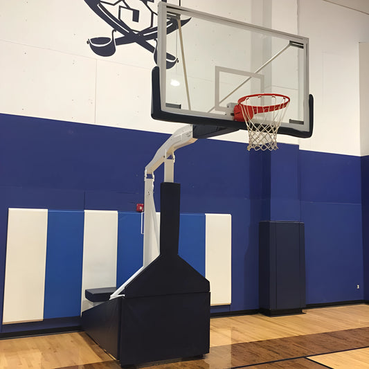 FIRST TEAM portable basketball hoop with adjustable height and sturdy base on indoor gym court