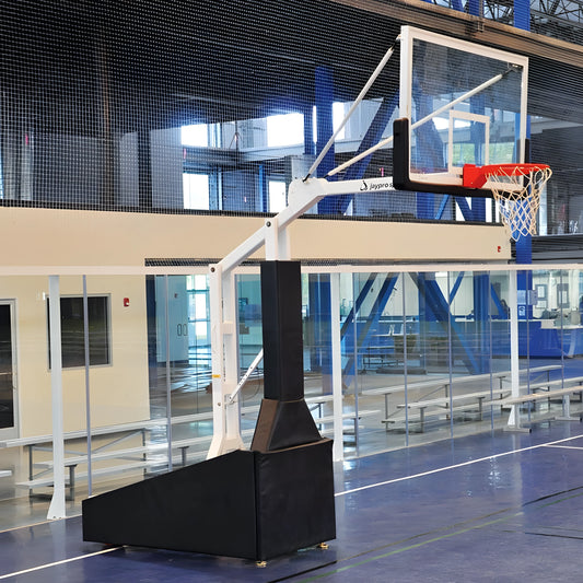 Jaypro portable basketball hoop with adjustable height and sturdy base on indoor gym court