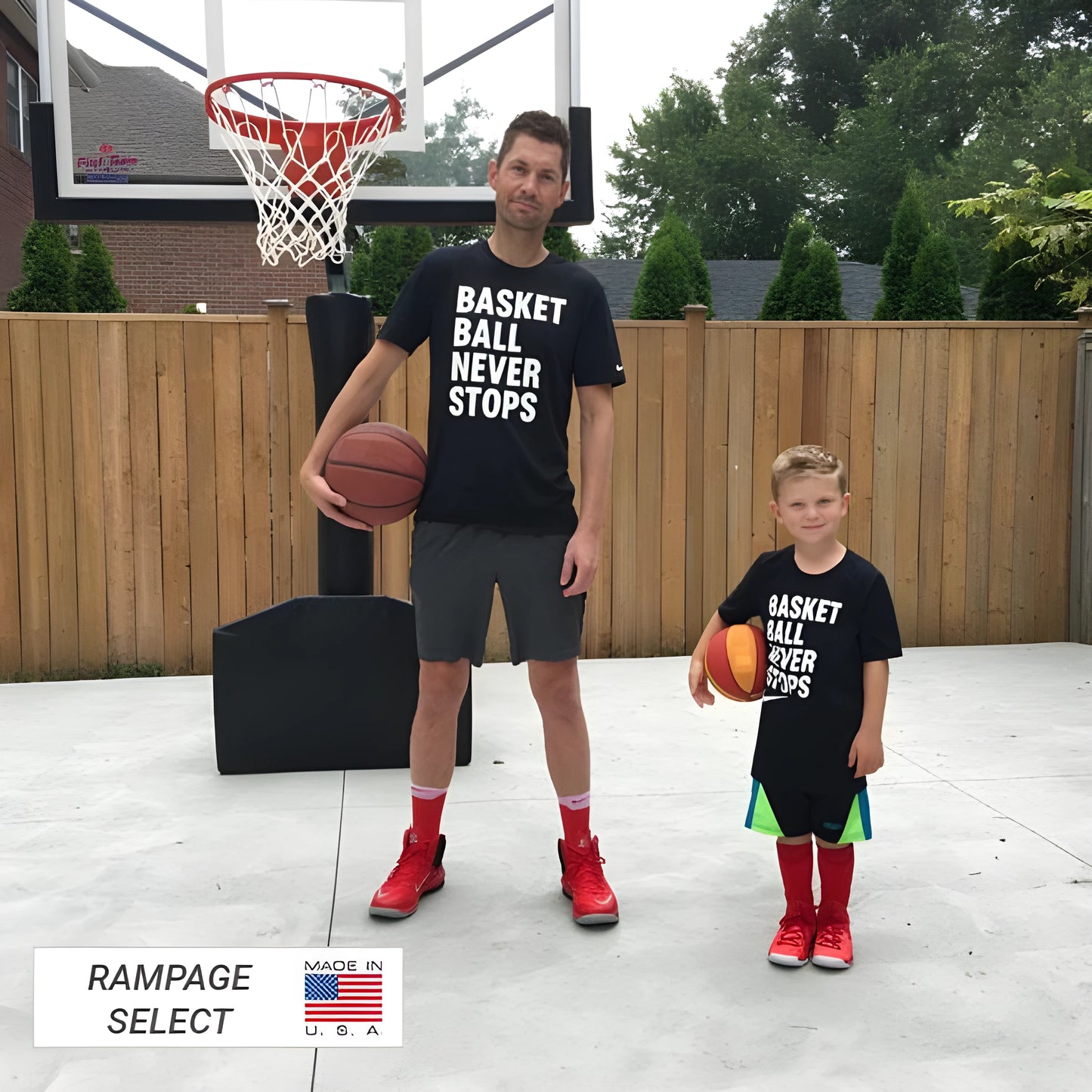 FIRST TEAM portable basketball hoop with adult and child holding basketballs on outdoor court