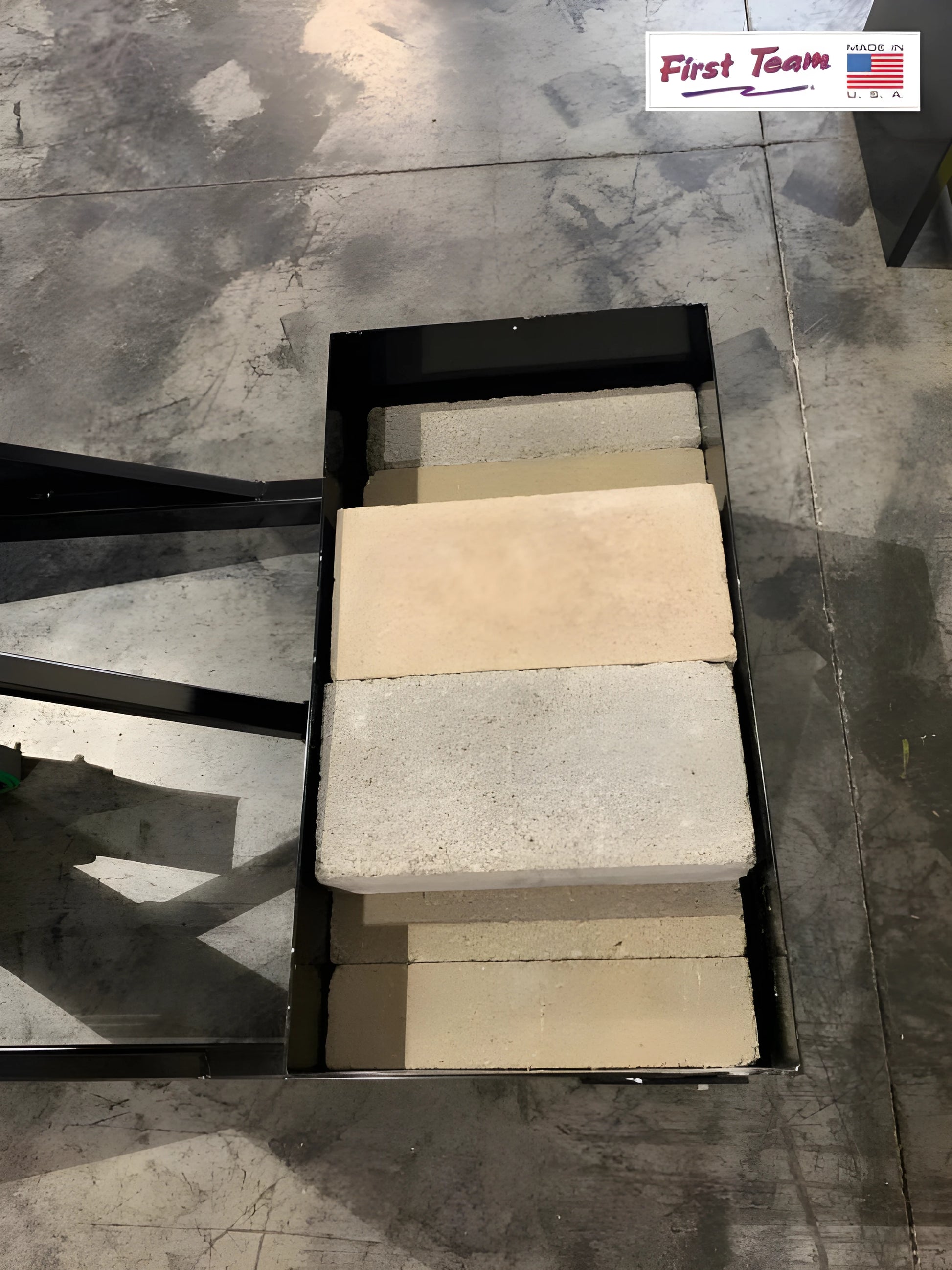 FIRST TEAM Portable Basketball Hoop base filled with concrete blocks for stability on a concrete floor