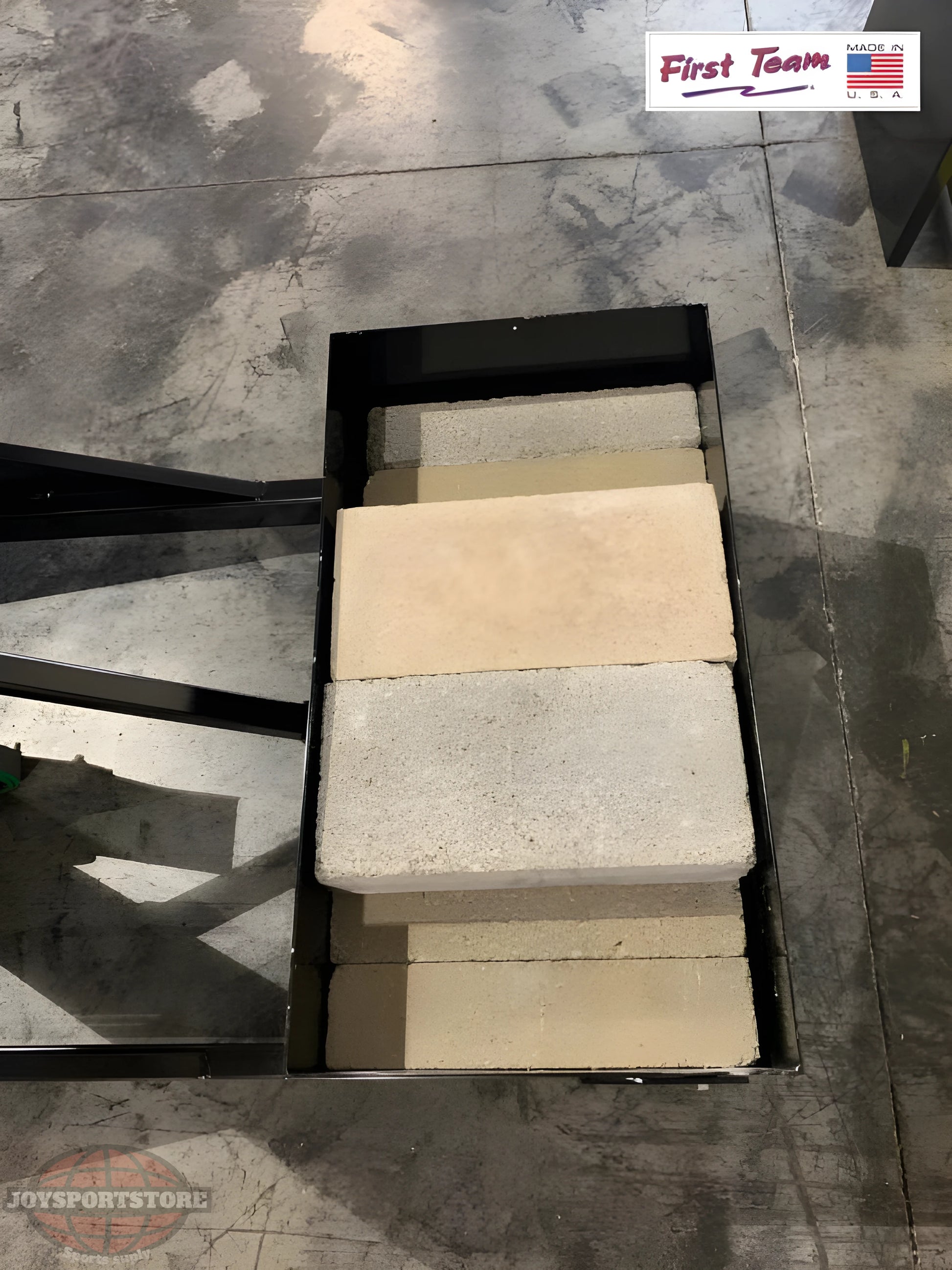 Base of FIRST TEAM portable basketball hoop weighted with concrete blocks for stability