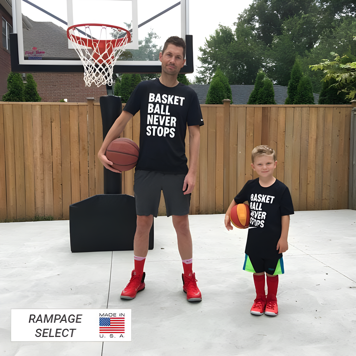 FIRST TEAM portable basketball hoop with adult and child holding basketballs on outdoor court