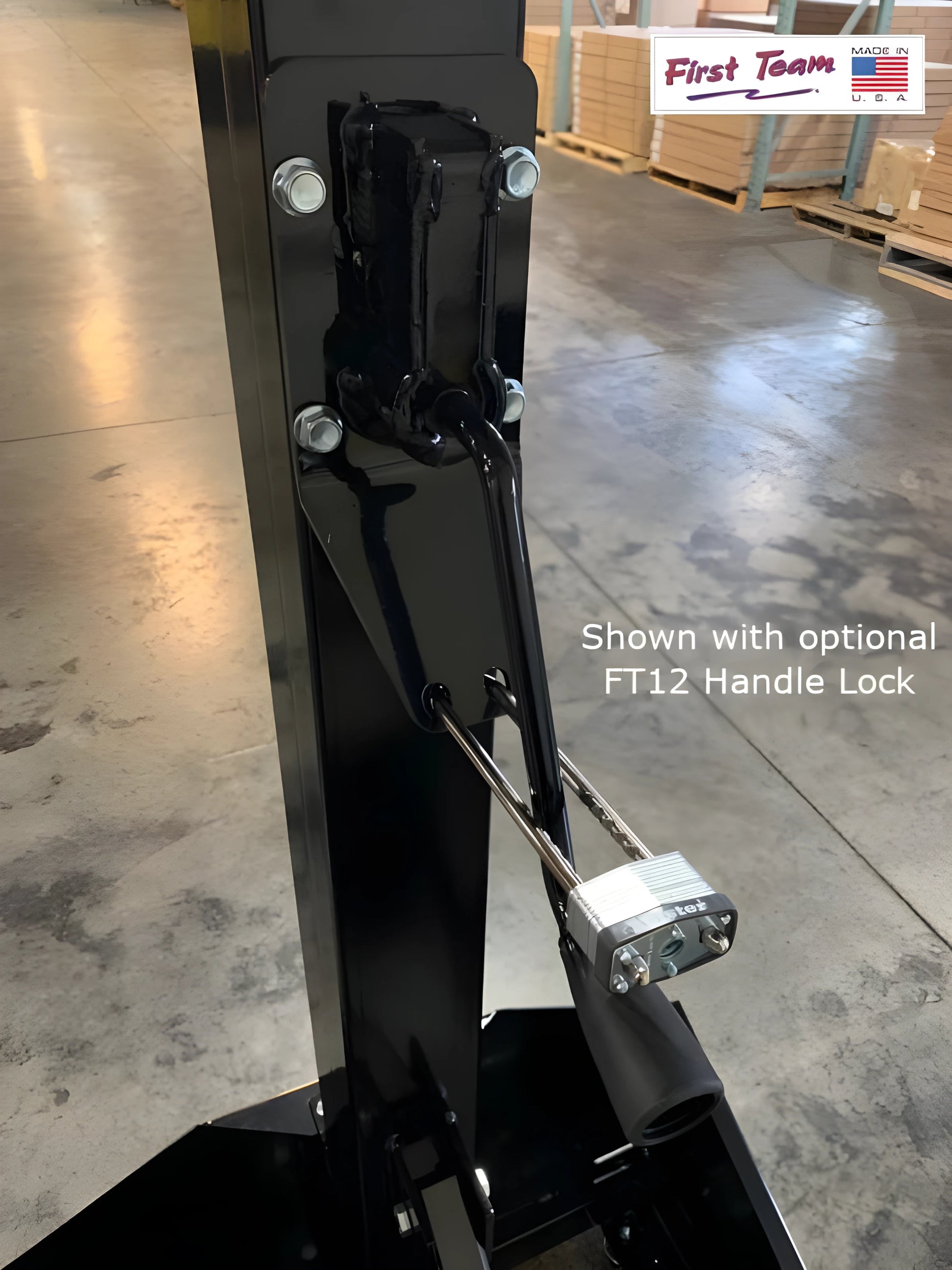 FIRST TEAM portable basketball hoop close-up showing black adjustable stand with optional FT12 handle lock in warehouse