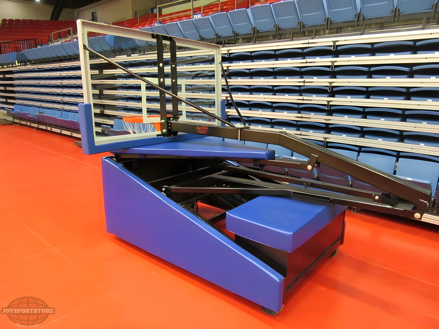 FIRST TEAM portable basketball hoop with padded base and adjustable glass backboard on gym floor