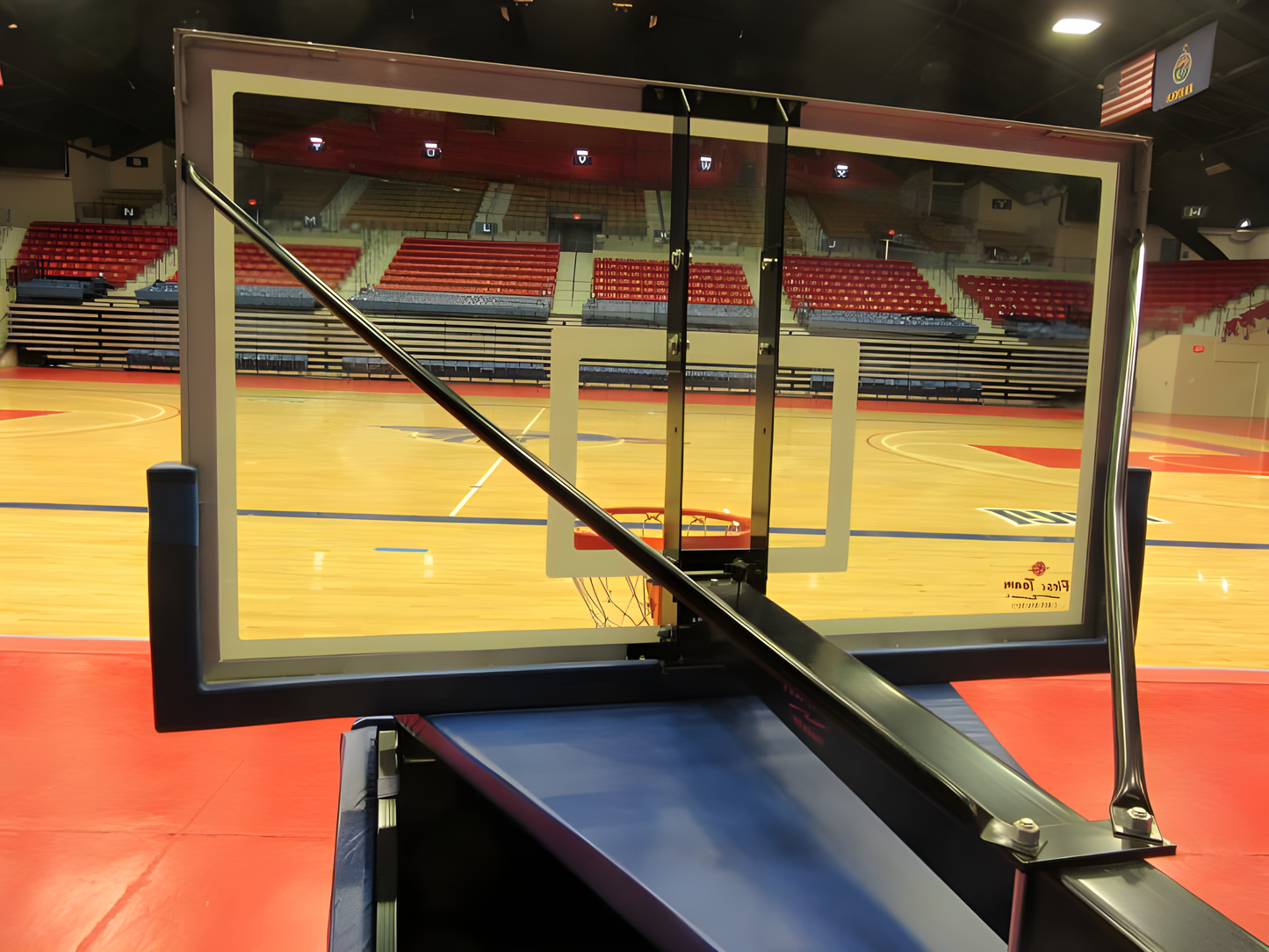 FIRST TEAM portable basketball hoop with clear backboard and sturdy support in indoor gym