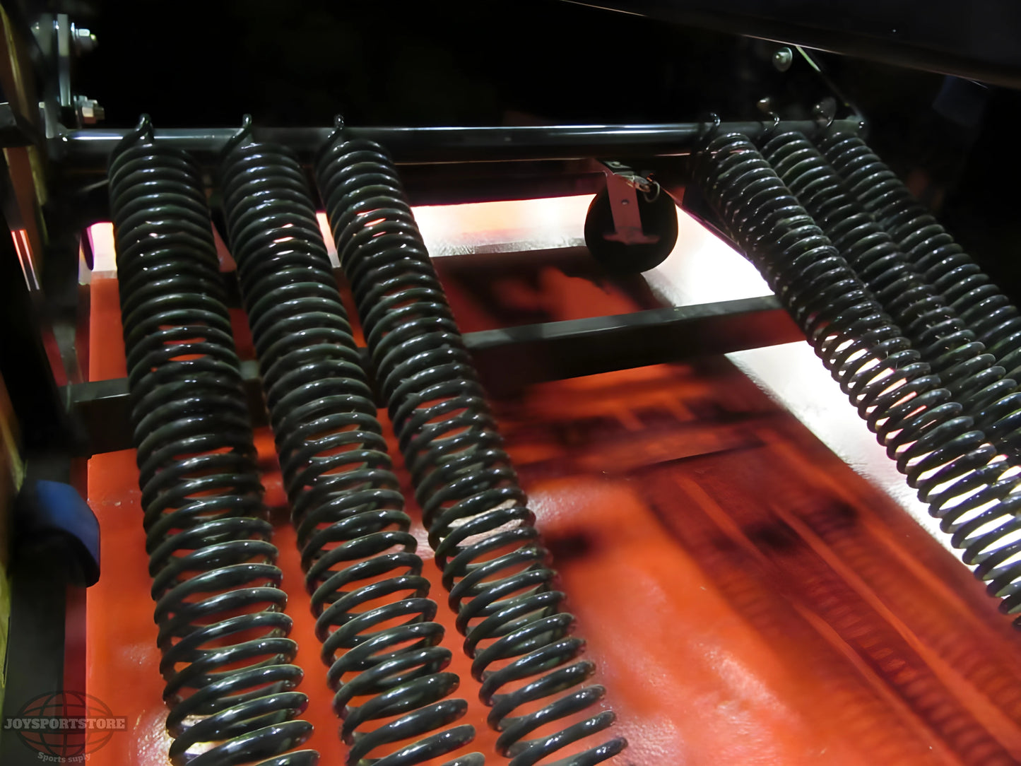 Close-up of heavy-duty springs on a FIRST TEAM Portable Basketball Hoop base for stability and durability
