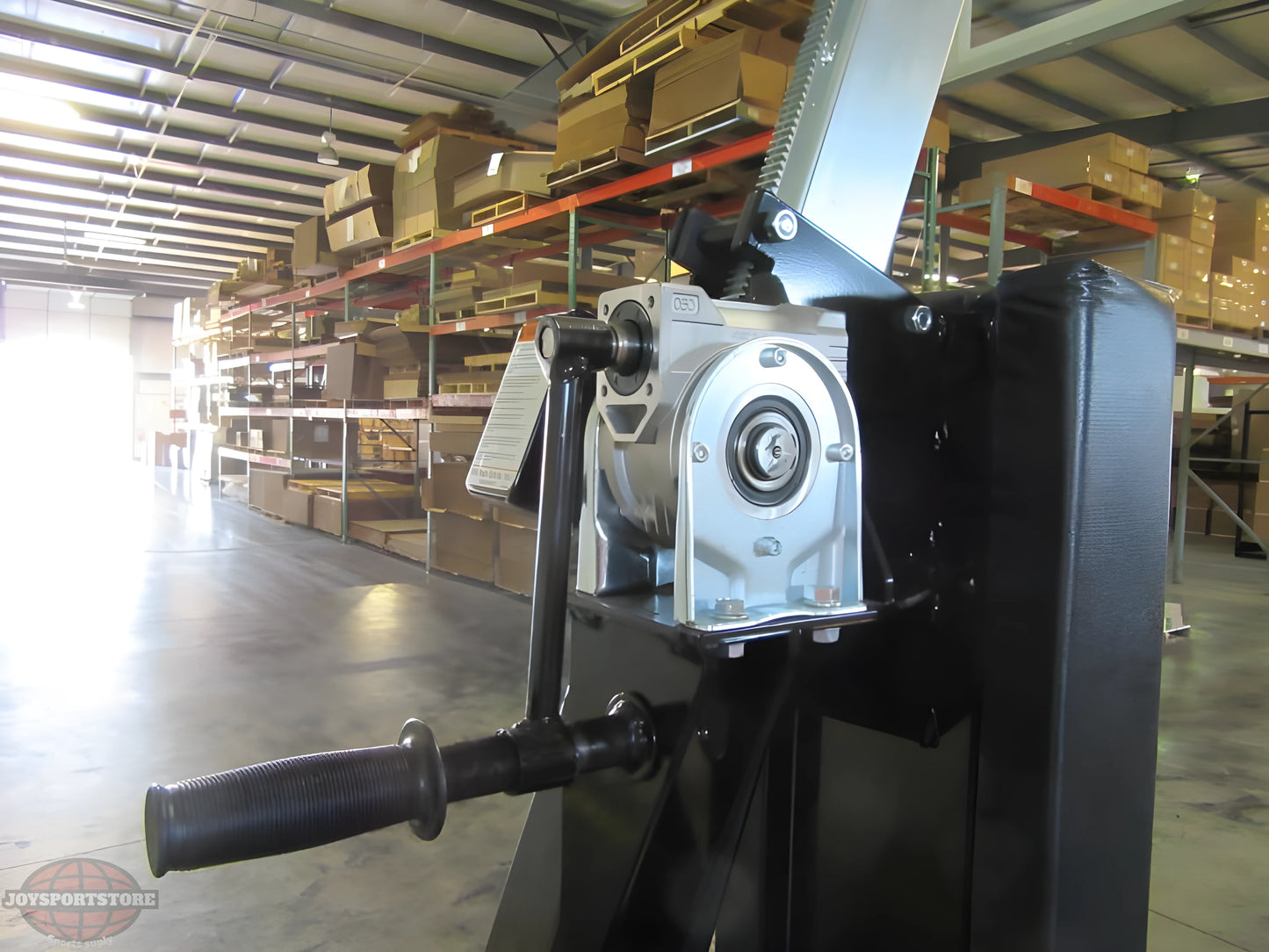 Close-up of adjustment mechanism on FIRST TEAM portable basketball hoop in warehouse