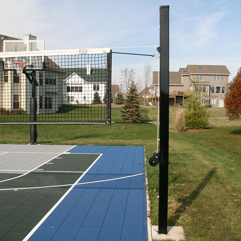 Douglas Aluminum Adjustable Net System with net raised on a multi-sport backyard court