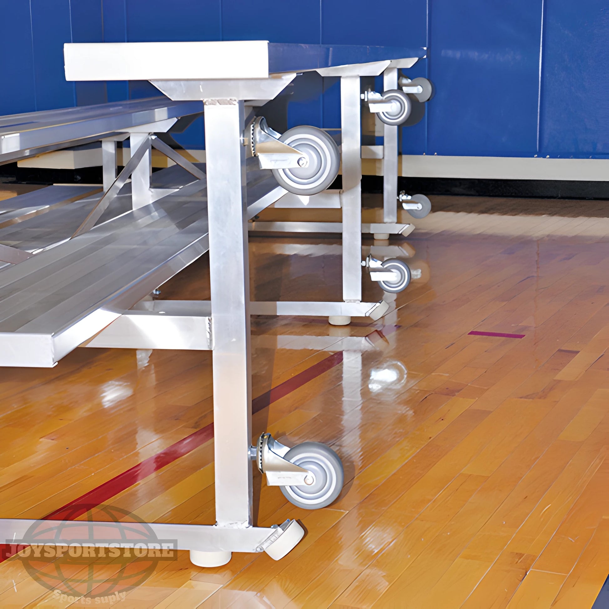 Indoor bleacher seats with aluminum frame and caster wheels on gym floor.