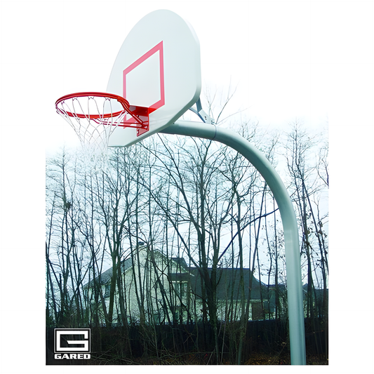 Gared outdoor basketball hoop with white backboard and red rim installed near leafless trees