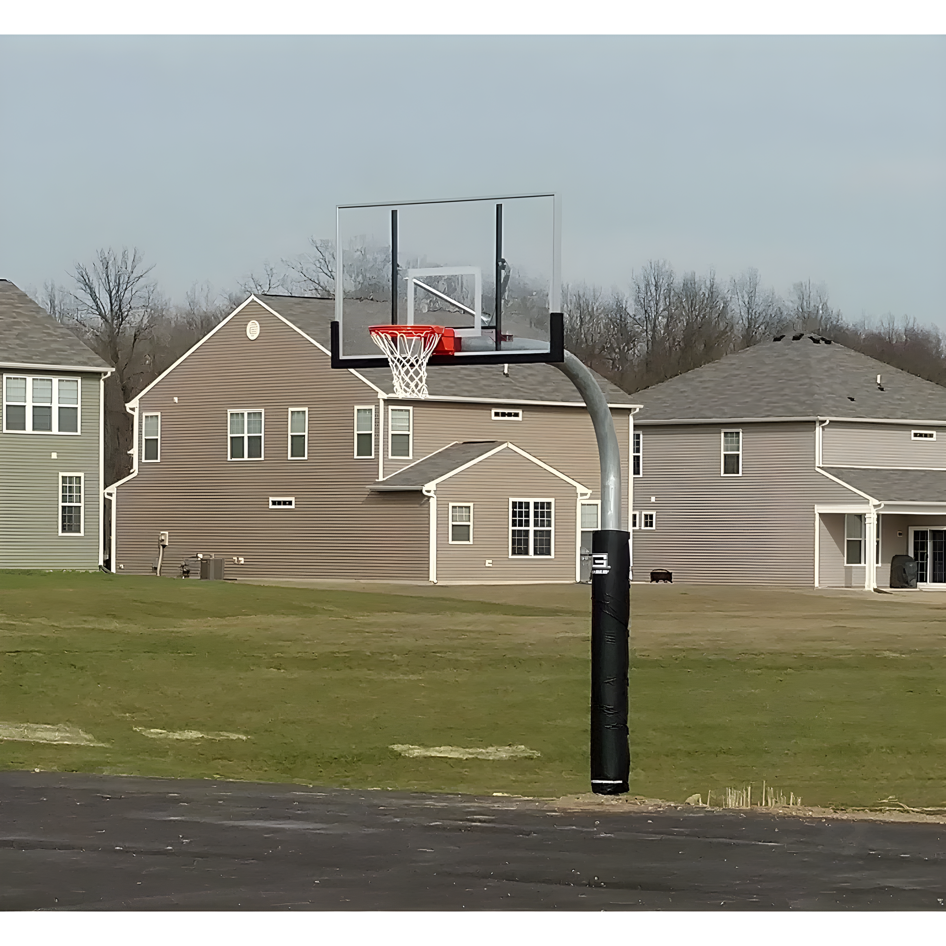 Gared outdoor basketball hoop with clear backboard and red rim installed on residential driveway