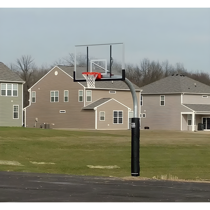 Gared outdoor basketball hoop with clear backboard and red rim installed on residential driveway