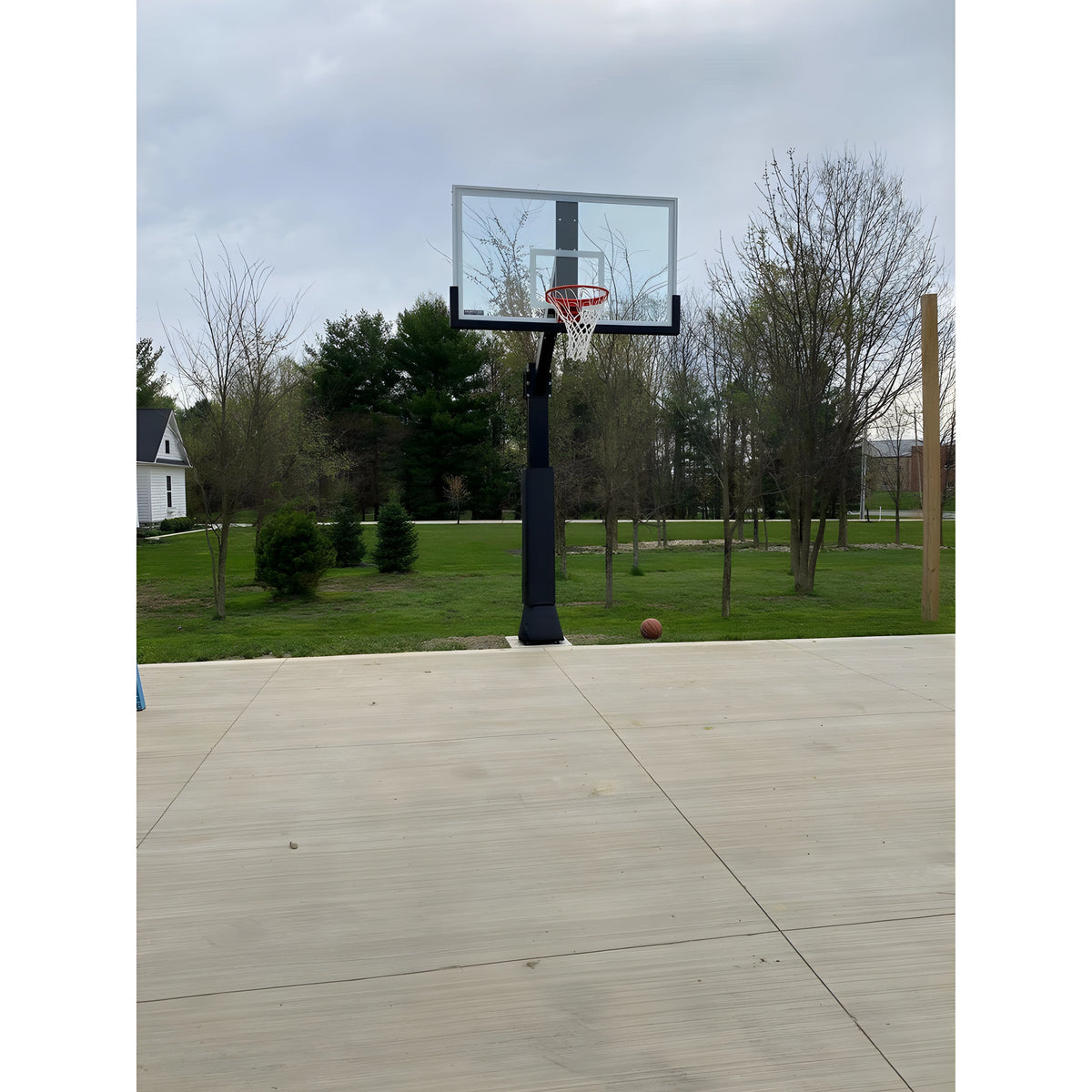 Ironclad Basketball Hoop with Adjustable Height in a Backyard Setting