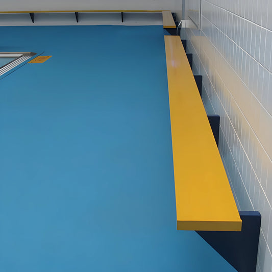 A blue swimming pool adjacent to a yellow bench from Jaypro Sports, enhancing the outdoor recreational area.