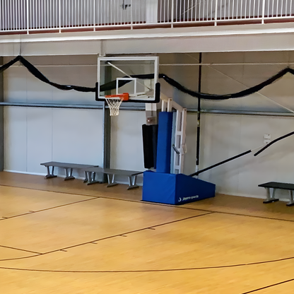 Jaypro portable basketball hoop with adjustable backboard and base padding inside indoor gym
