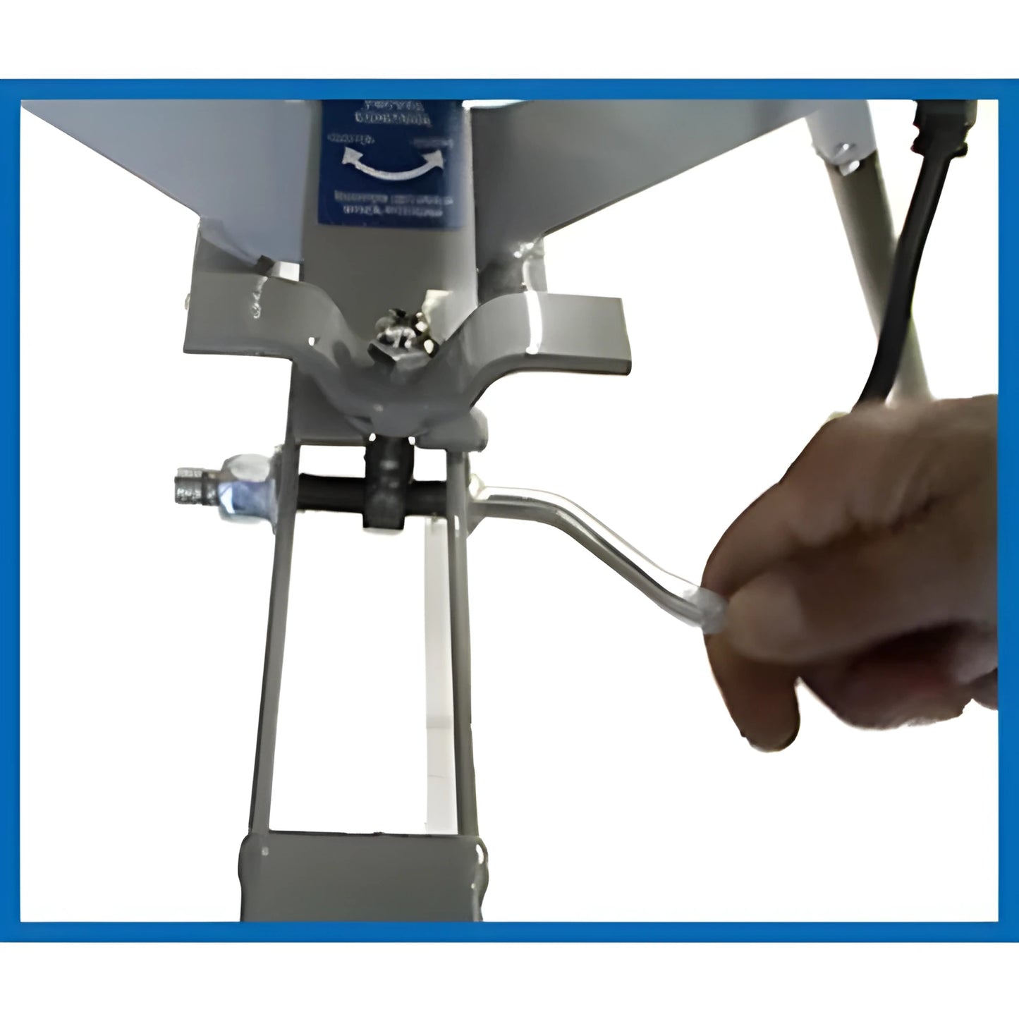 Hand adjusting the lever on a Sports Attack Pitching Machine for precise pitch control